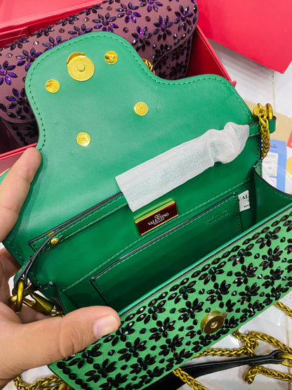 Valentino Garavani Locò velvet clutch with jewel logo