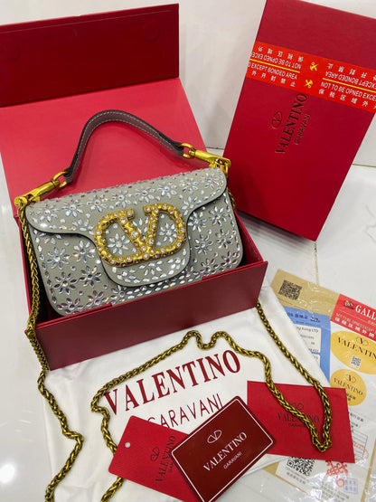 Valentino Garavani Locò velvet clutch with jewel logo