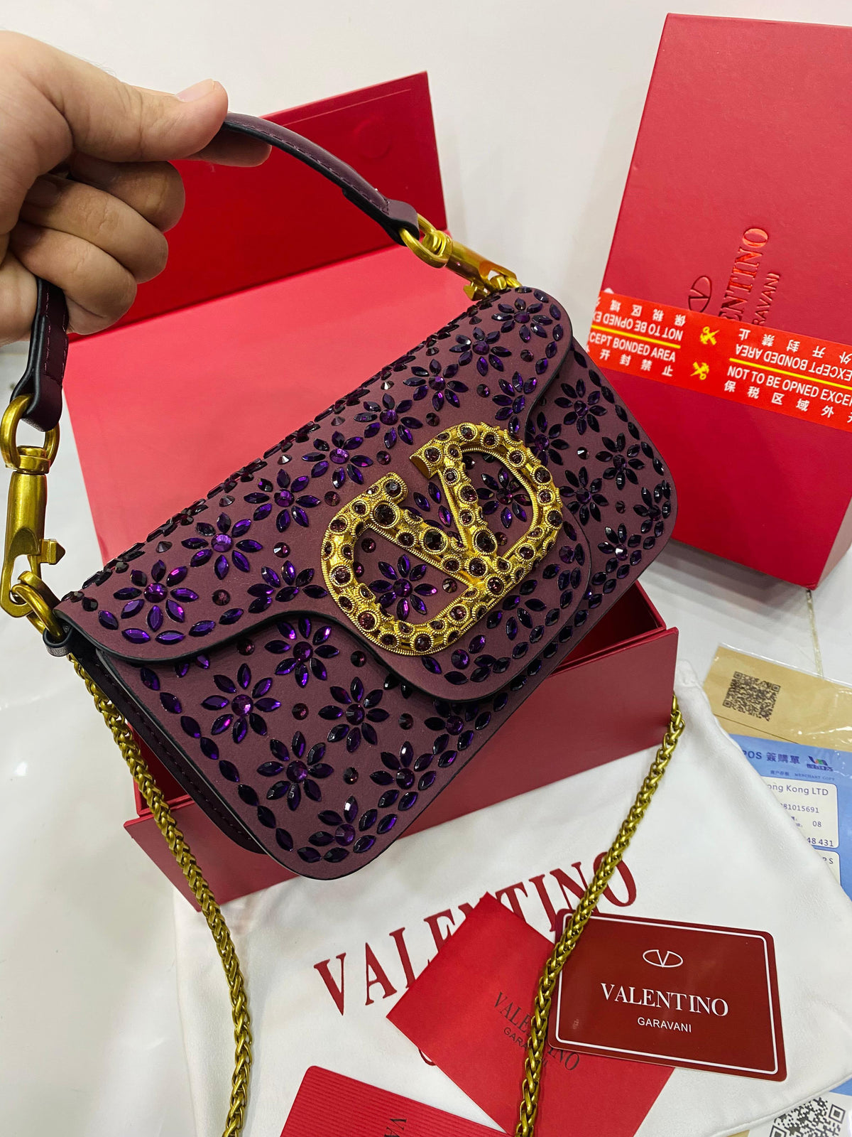 Valentino Garavani Locò velvet clutch with jewel logo